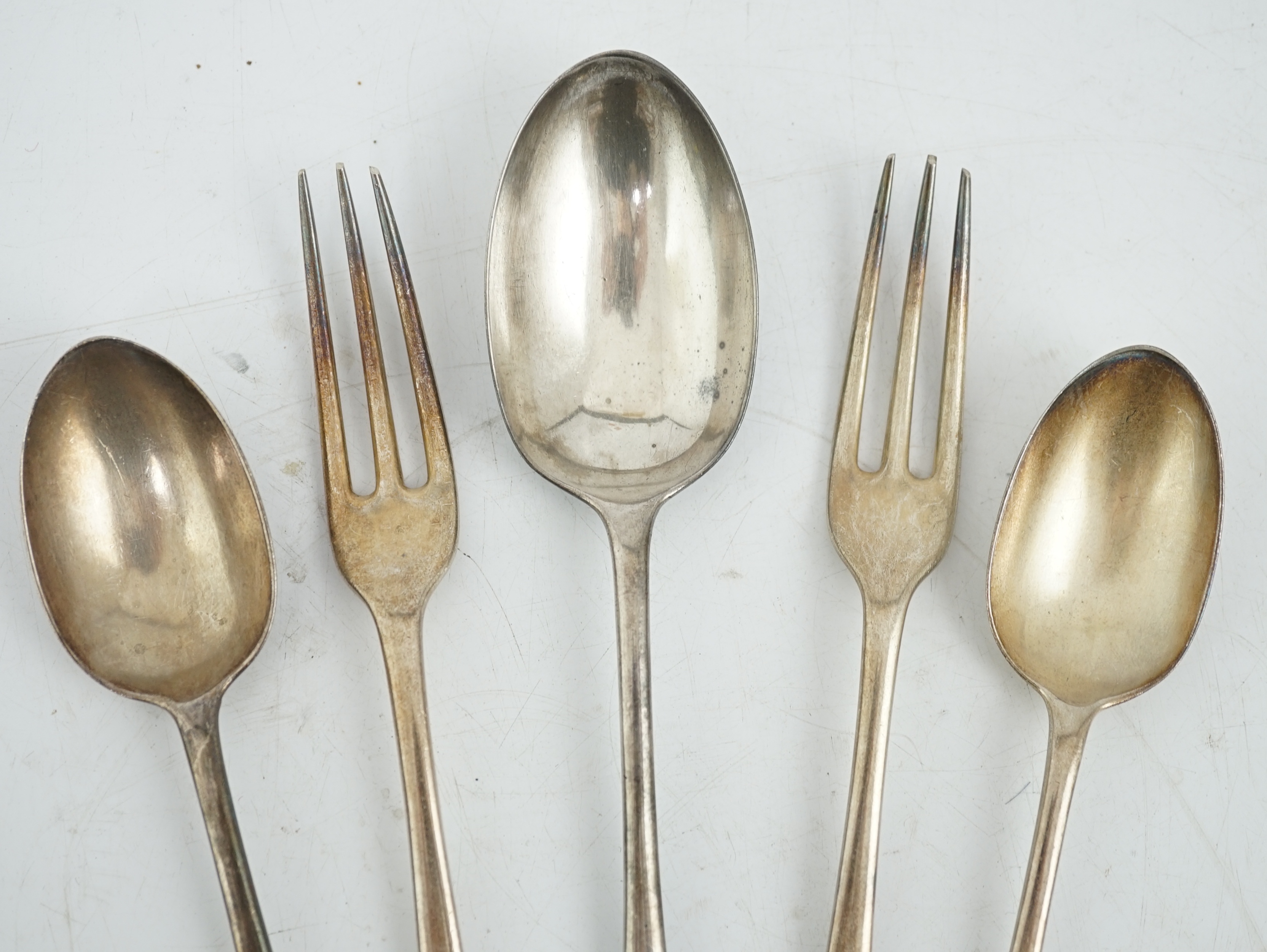 Sundry silver, consisting of three pieces of George III flatware, two 800 standard coffee spoons, a pair of candlesticks(a.f.), a lidded glass preserve pot, clothes brush, two pepperettes and a desk seal.
